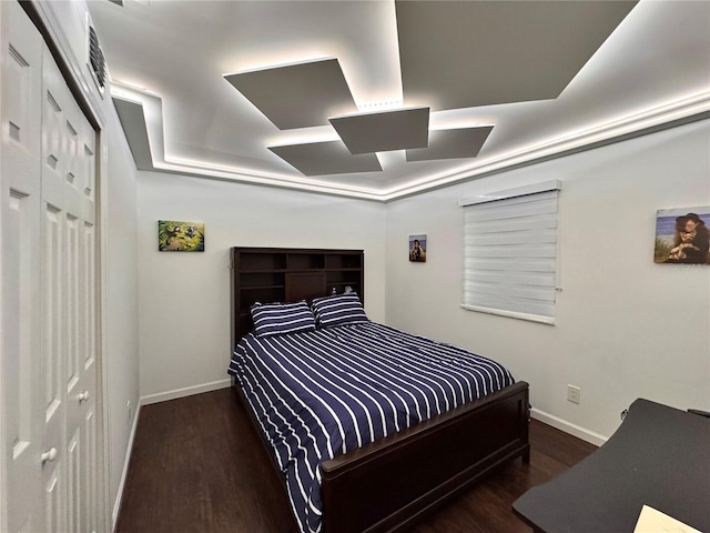 bedroom featuring a closet and dark wood-type flooring