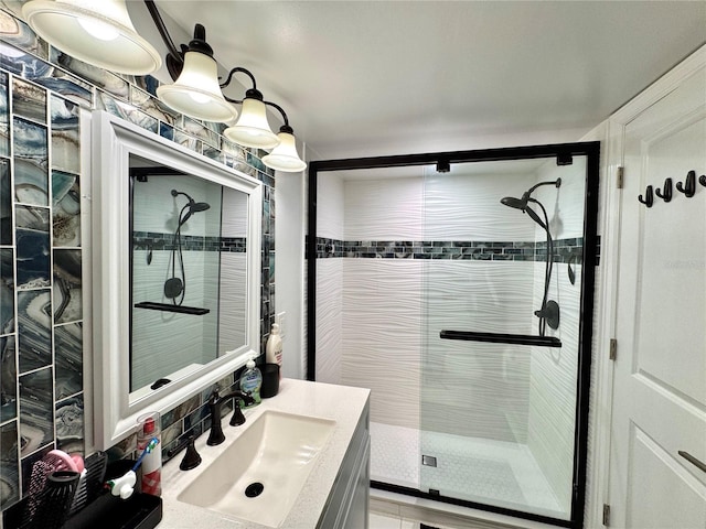 bathroom featuring vanity and a shower with shower door