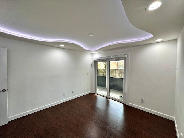 spare room featuring dark wood-type flooring