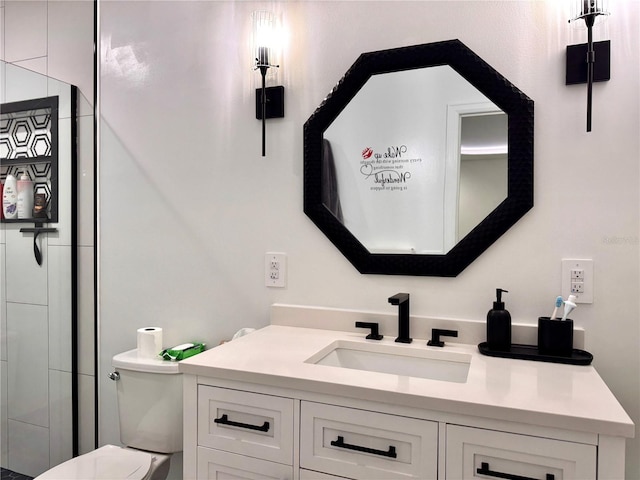 bathroom featuring vanity, toilet, and a shower with door