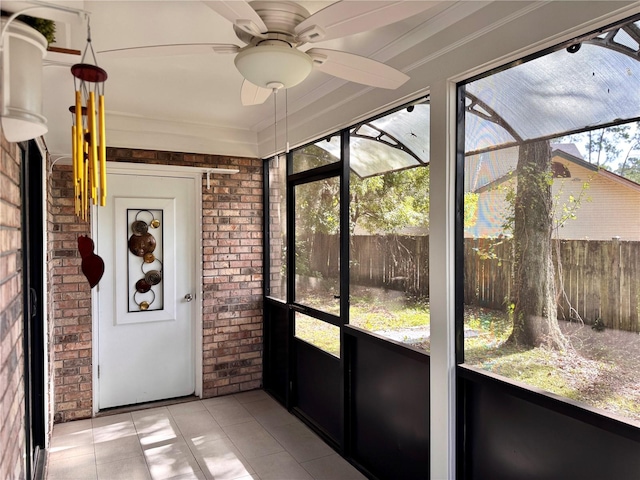 unfurnished sunroom with a wealth of natural light and ceiling fan