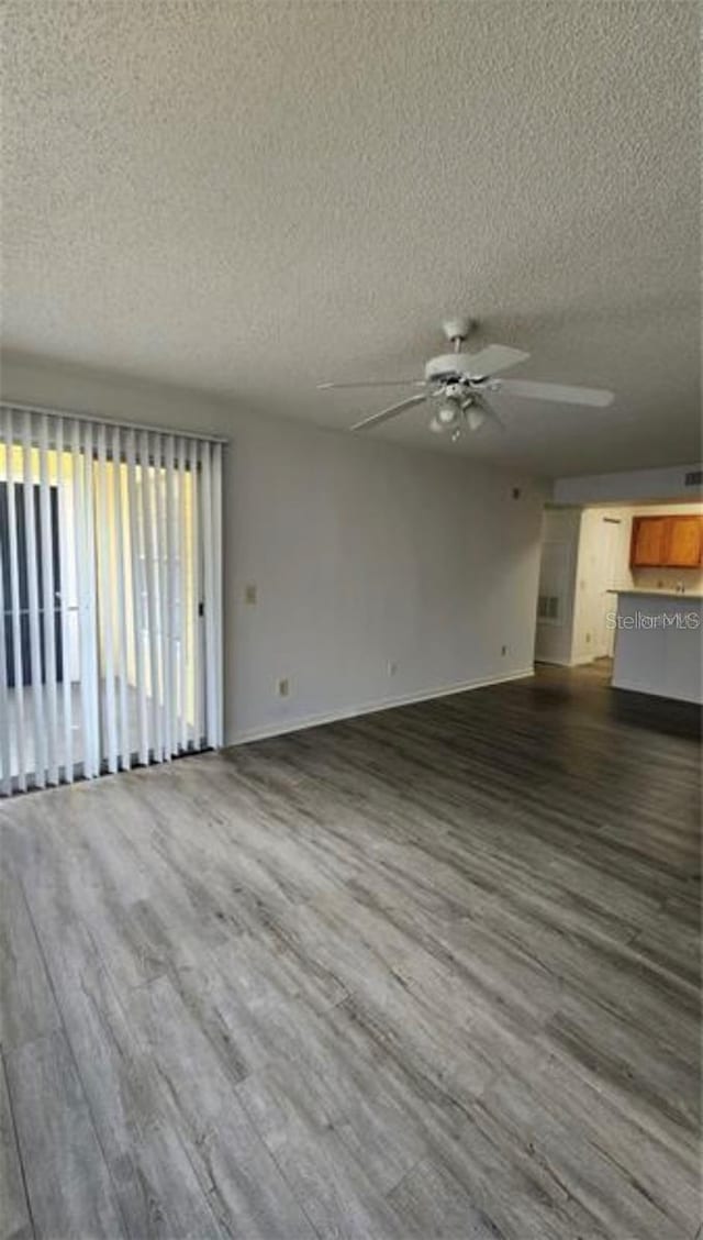 unfurnished living room with a textured ceiling, hardwood / wood-style flooring, and ceiling fan