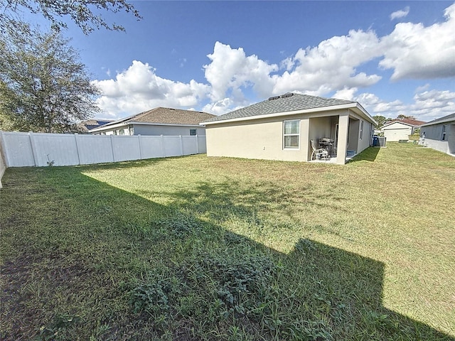 rear view of property featuring a yard