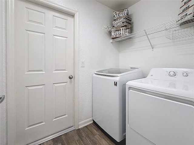 washroom with washer and clothes dryer and dark wood-type flooring