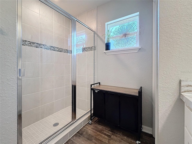 bathroom featuring an enclosed shower and hardwood / wood-style flooring