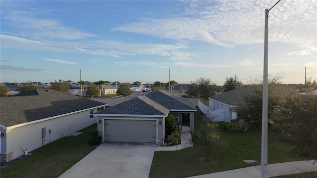 view of front of home featuring a front yard and a garage