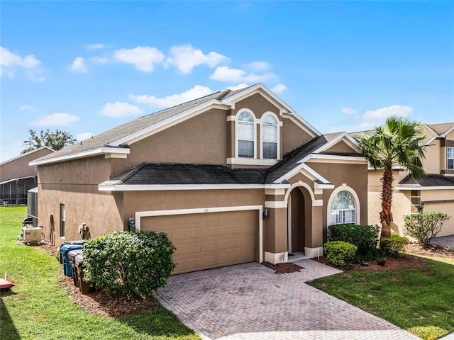 view of front facade with a front yard and a garage