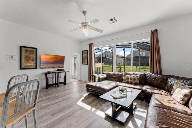131 Cadiz Loop, Davenport, FL 33837 - living room featuring ceiling fan, light wood-style flooring, and baseboards