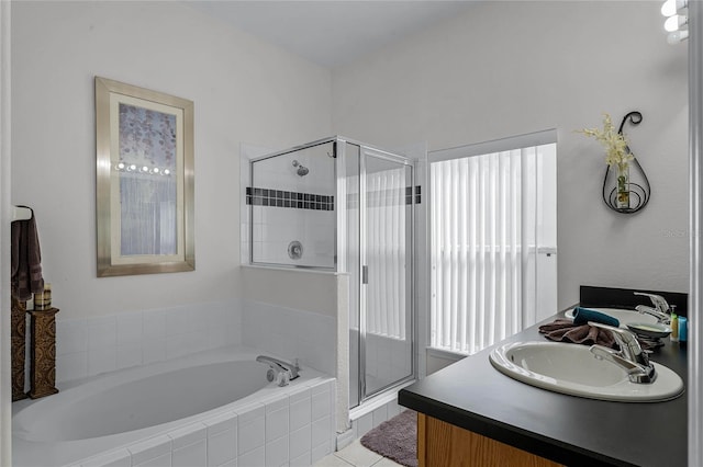 131 Cadiz Loop, Davenport, FL 33837 - full bathroom featuring a stall shower, a garden tub, double vanity, and tile patterned flooring