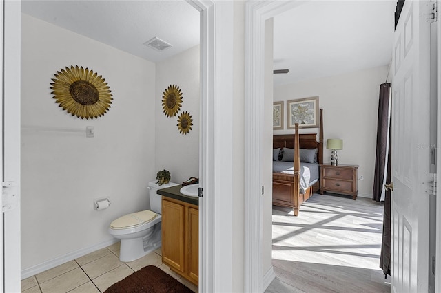 bathroom featuring hardwood / wood-style floors, vanity, and toilet