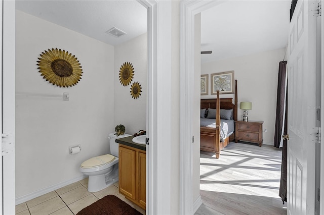 131 Cadiz Loop, Davenport, FL 33837 - bathroom with toilet, tile patterned flooring, vanity, and baseboards