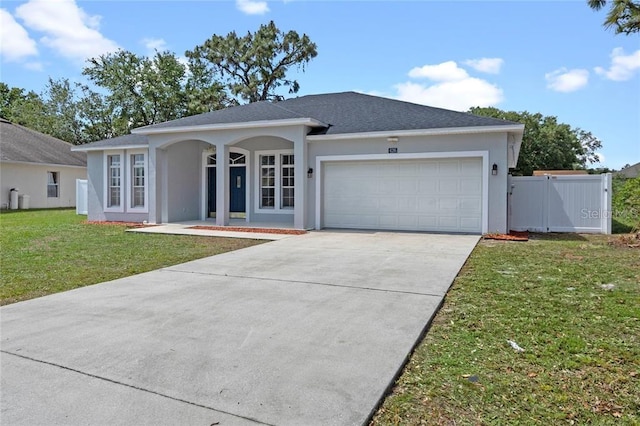 ranch-style home with a front lawn and a garage