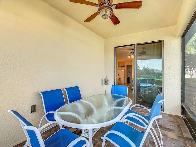 sunroom featuring ceiling fan