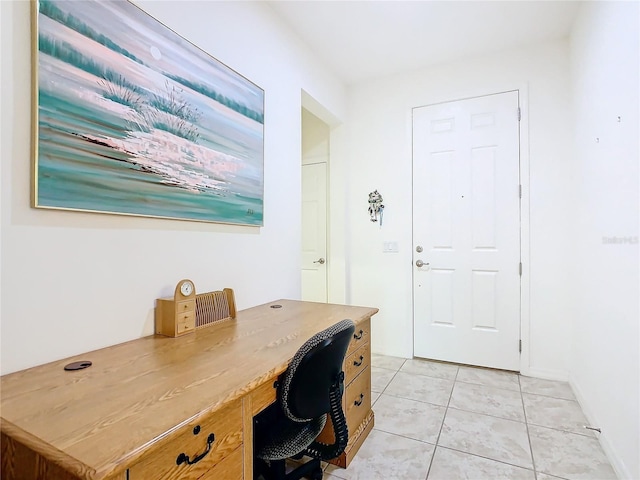 office space featuring built in desk and light tile patterned floors