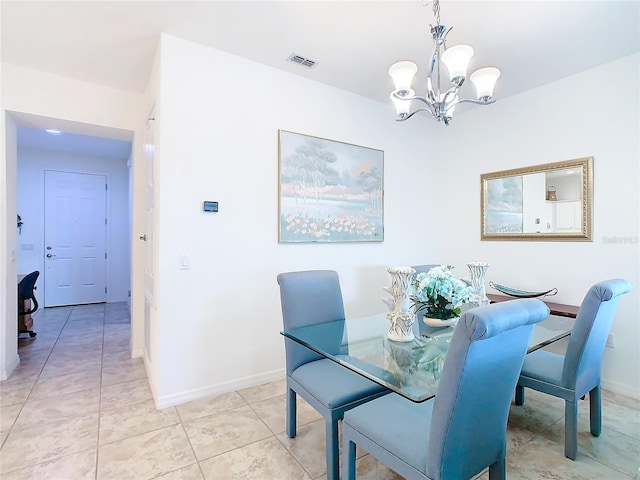 tiled dining space with a notable chandelier