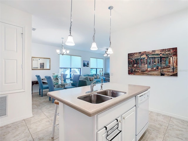 kitchen with white cabinetry, sink, hanging light fixtures, white dishwasher, and a center island with sink