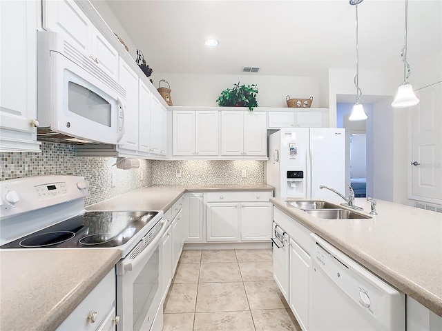 kitchen featuring decorative light fixtures, white cabinetry, white appliances, and sink