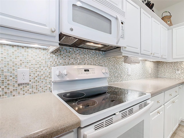 kitchen with decorative backsplash, white cabinetry, and white appliances