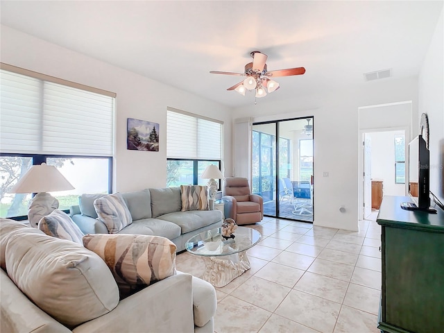 tiled living room with plenty of natural light and ceiling fan