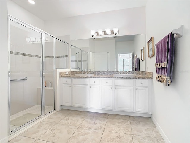 bathroom with tile patterned flooring, vanity, and walk in shower