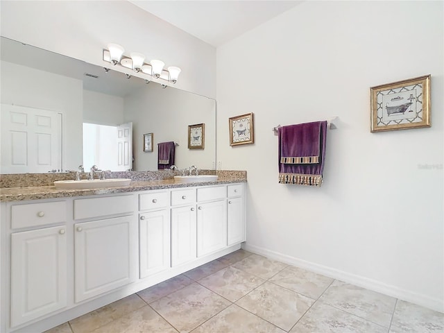 bathroom featuring tile patterned flooring and vanity