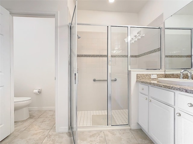 bathroom with an enclosed shower, vanity, toilet, and tile patterned flooring