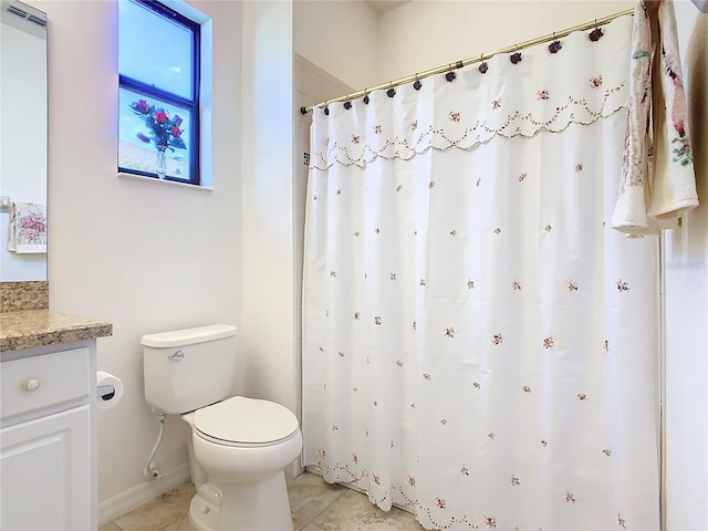 bathroom featuring tile patterned floors, vanity, and toilet