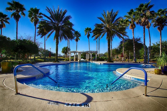 view of swimming pool featuring a pergola