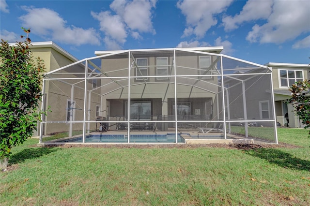 rear view of property with a lanai and a yard