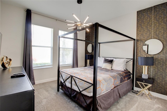 carpeted bedroom featuring ceiling fan with notable chandelier