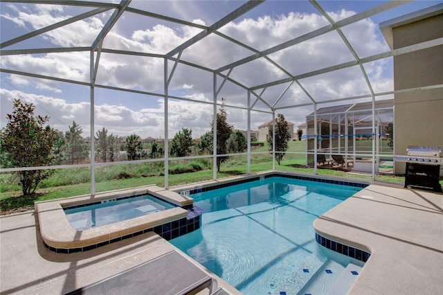 view of pool featuring glass enclosure, a patio area, and an in ground hot tub