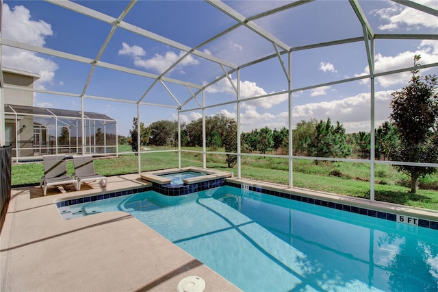 view of pool with an in ground hot tub, a patio, and glass enclosure