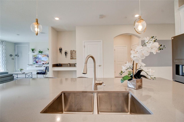 712 Whistling Straits Blvd, Davenport, FL 33896 - kitchen with a sink, arched walkways, decorative light fixtures, light countertops, and recessed lighting