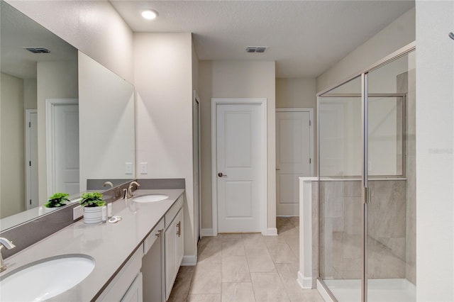 712 Whistling Straits Blvd, Davenport, FL 33896 - bathroom featuring double vanity, a stall shower, baseboards, and a textured ceiling