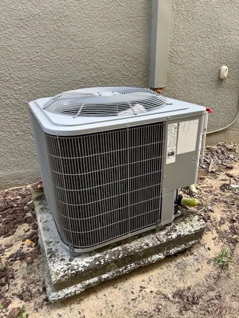 712 Whistling Straits Blvd, Davenport, FL 33896 - exterior view of cooling unit and stucco siding