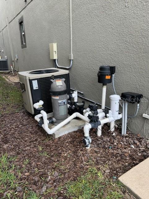 712 Whistling Straits Blvd, Davenport, FL 33896 - exterior view of stucco siding and central air condition unit