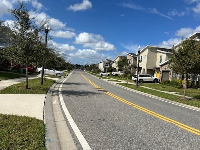 712 Whistling Straits Blvd, Davenport, FL 33896 - view of asphalt road featuring a residential view, street lighting, sidewalks, and curbs