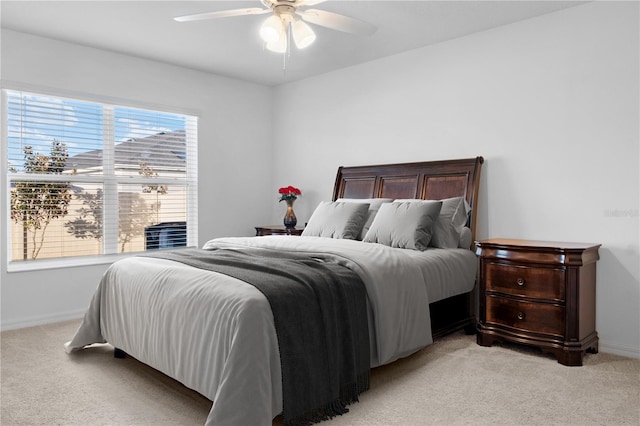 bedroom with light colored carpet and ceiling fan