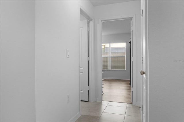 corridor featuring light tile patterned flooring