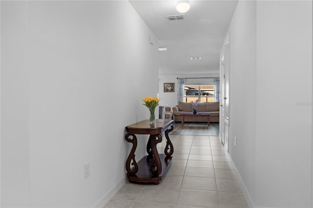 corridor featuring light tile patterned flooring