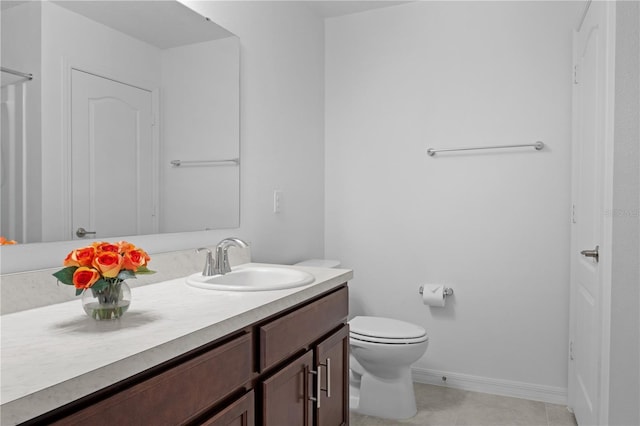 bathroom with tile patterned floors, vanity, and toilet