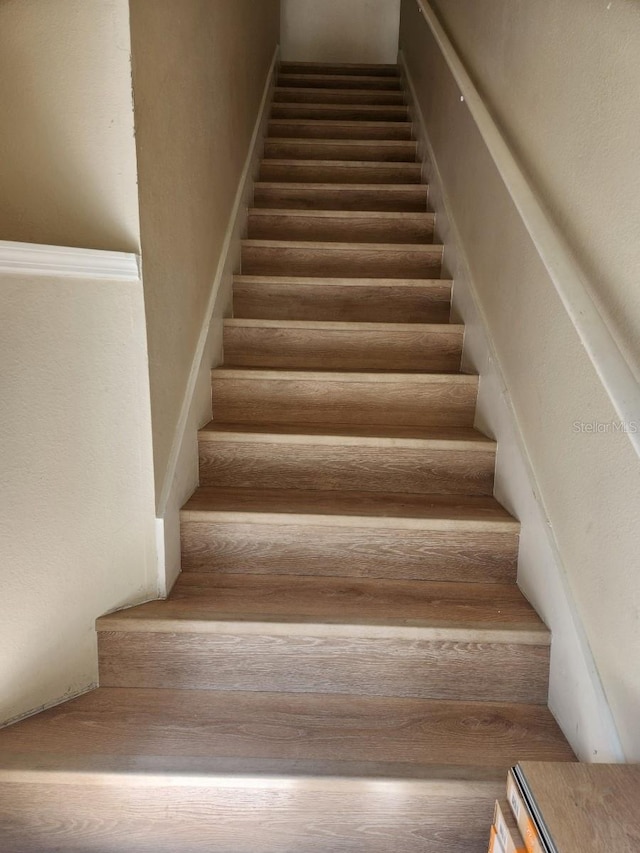 stairway with wood-type flooring