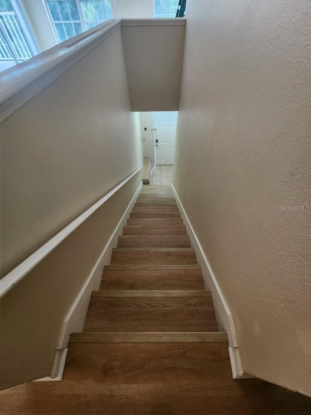 stairs featuring hardwood / wood-style floors