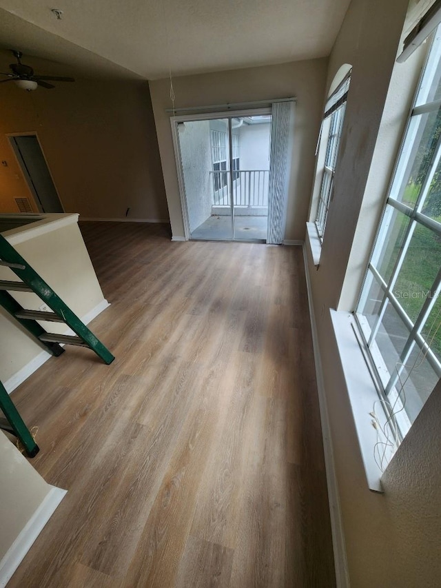 interior space featuring hardwood / wood-style floors, ceiling fan, and a healthy amount of sunlight