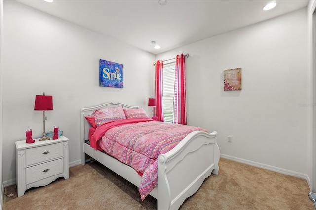 bedroom featuring light colored carpet