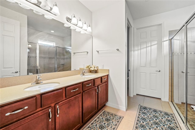 bathroom featuring vanity, tile patterned floors, and a shower with shower door