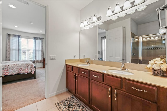 bathroom with tile patterned flooring, vanity, and a shower with shower door