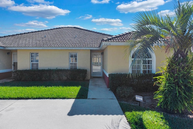 2216 Mystic Ring Loop, Poinciana, FL 34759 - view of front of home featuring stucco siding and a tile roof