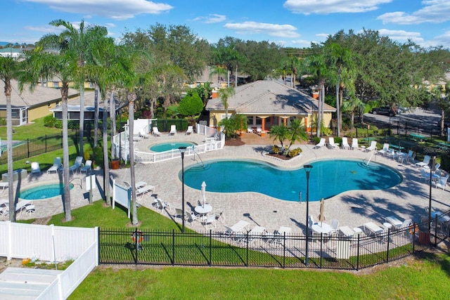 2216 Mystic Ring Loop, Poinciana, FL 34759 - community pool with a fenced backyard, a patio area, and a community hot tub