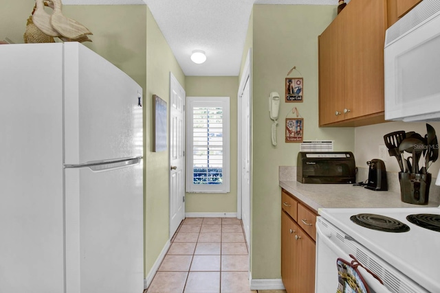 2216 Mystic Ring Loop, Poinciana, FL 34759 - kitchen featuring white appliances, light countertops, light tile patterned flooring, and brown cabinetry